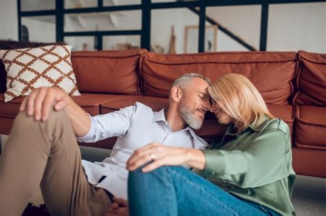 Premium Photo Mature Couple Sitting On The Floor And Looking Relaxed