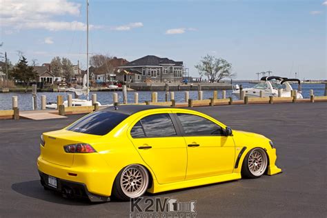 Yellow sedan, car, yellow cars, Mitsubishi Lancer Evo X, harbor HD wallpaper | Wallpaper Flare