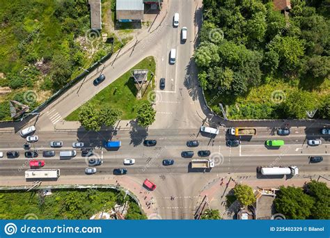 Top Down Aerial View Of Busy Street Intersection With Moving Cars