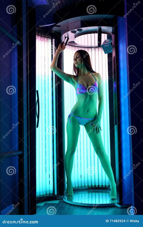 Leggy Brunette Tans In Modern Tanning Booth Stock Photo Image Of Equipment Lamp
