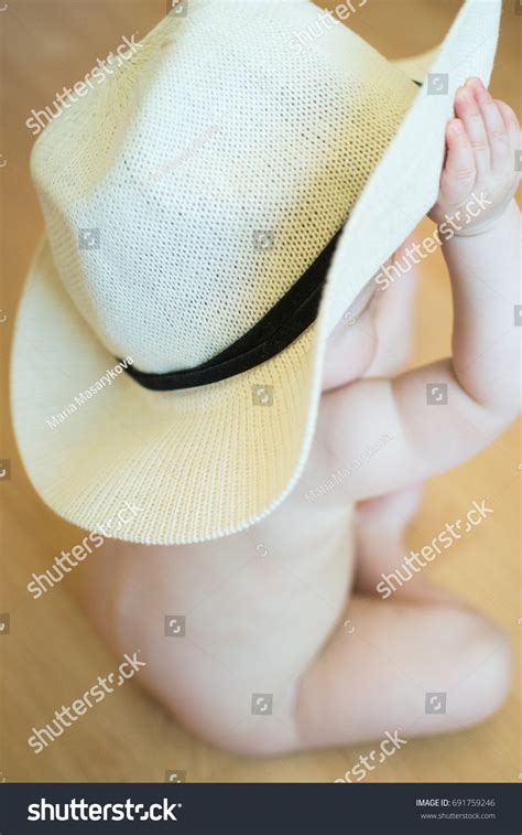 Naked Baby Sitting On Floor Holding Stock Photo Shutterstock