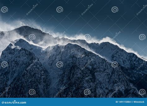 Beautiful High Snowy And Foggy Mountains With Snow Being Blown By Wind