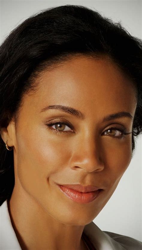 a close up of a person wearing a white shirt and brown tie with her ...