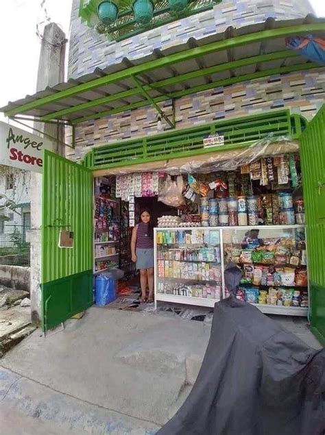 A Man Standing In The Doorway Of A Store Filled With Food And Drink