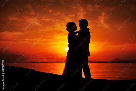 Silhouette of couple kissing in sunset Stock Photo | Adobe Stock