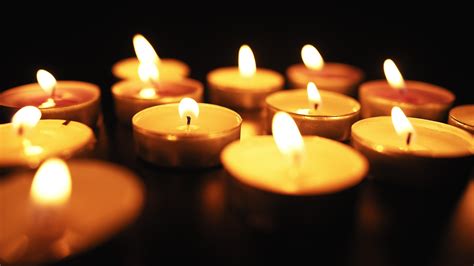 Candles Burn with a Soft Yellow Flame in the Dark. Religion and Funeral
