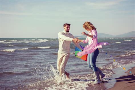 Couple Enjoying Time Together At Beach Stock Photo At Vecteezy