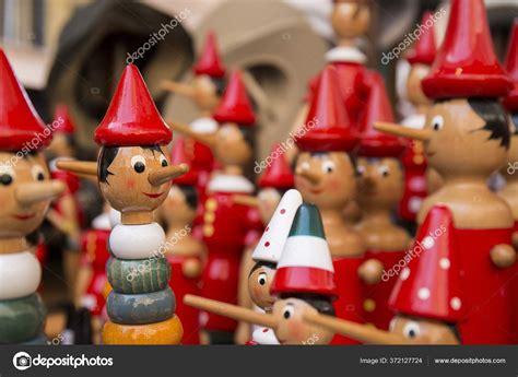 Wooden Puppet Set Long Nose Red Hats Stock Photo By ©wirestock 372127724