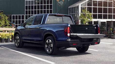 The Back End Of A Blue Pick Up Truck Parked In A Parking Lot Next To A