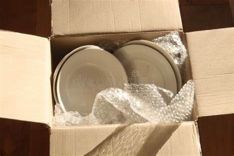 Cardboard Packing Box Plates And Bubble Wrap Stock Photo Image Of