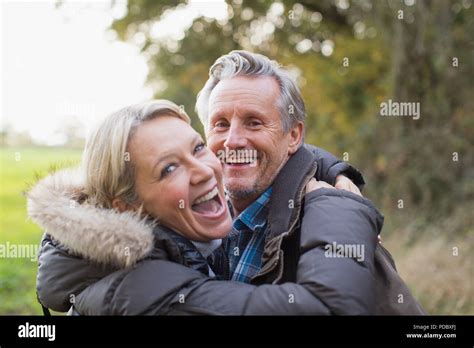 Portrait Happy Mature Couple Hugging In Park Stock Photo Alamy