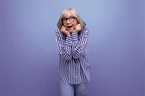 Shocked Mature Old Woman With Gray Hair On A Bright Studio Background With Copy Space Stock