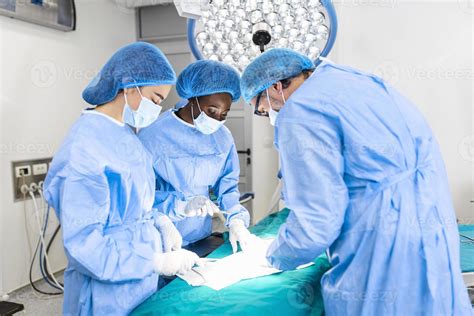 Portrait Of Team Of Multiethnic Surgeons At Work In A Operation Theatre