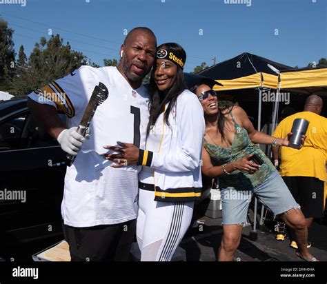 Steeler Fans Pose For Picture At A Tailgate Party Before An NFL