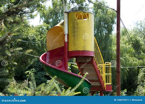 Colorful Playground Slide With Beautiful Trees In The Background Stock