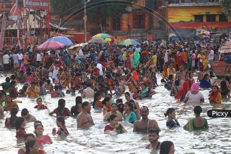 Image Of Hindu Devotees Taking Holy Bath In Triveni Sangam River At