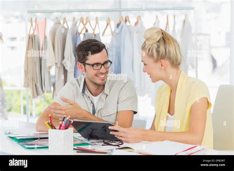 Fashion Designers Discussing Designs Stock Photo Alamy