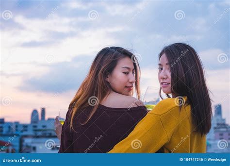 Two Female Lesbian Lgbt Couple Celebrate Anniversary With Champaign At Roof Top Party In Sunset