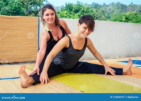 Beautiful Girl Together With A Yoga Instructor Doing Stretching In A Yoga Class Stock Image