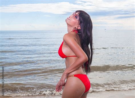 Sexy Asian Red Bikini Female Lady Model Having A Great Holiday By A Beach And Posing Happily