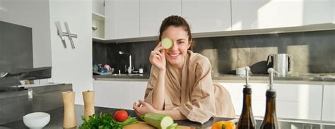Free Photo Portrait Of Smiling Brunette Woman Girl Cooks Vegetables Posing With Peace Of