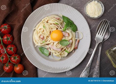 Delicious Pasta Carbonara With Egg Yolk Served On Grey Table Flat Lay