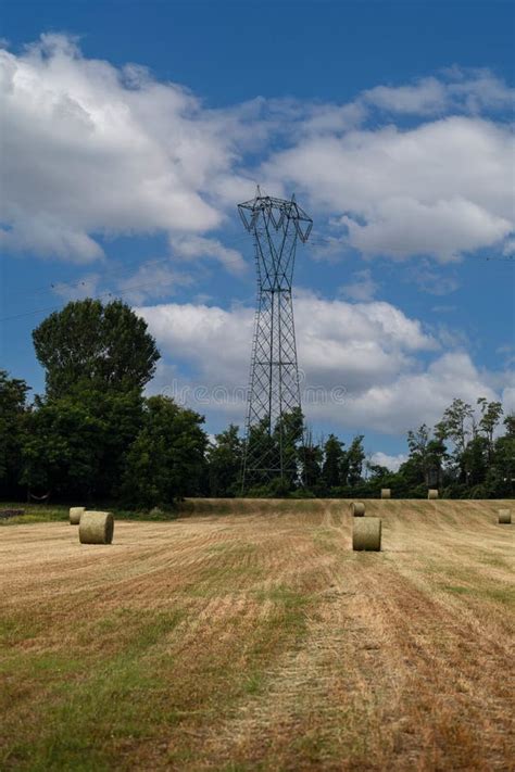 High Voltage Pylons Against A Blue Sky With White Clouds Stock Image