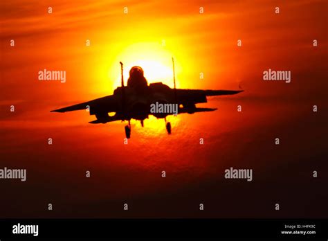 Usaf F 15e Eagle Passing Across The Setting Sun At Raf Lakenheath Stock