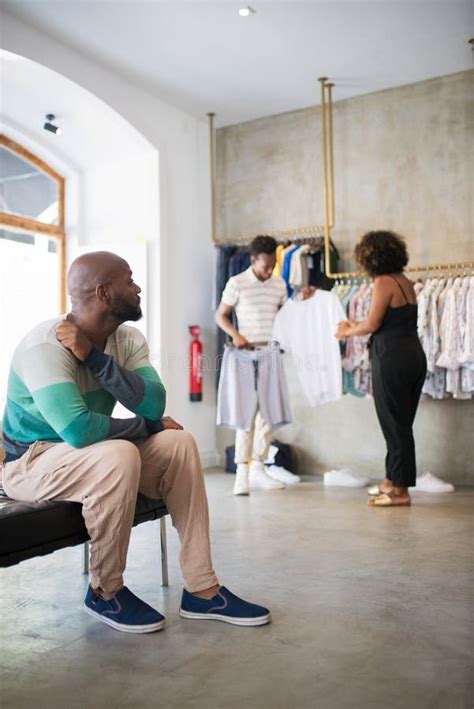 Portrait Of Gay Man Looking At His Boyfriend Choosing Clothes Stock Photo Image Of Love