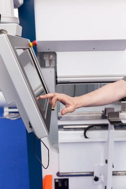 Premium Photo Cropped Hand Of Man Operating Machine In Factory