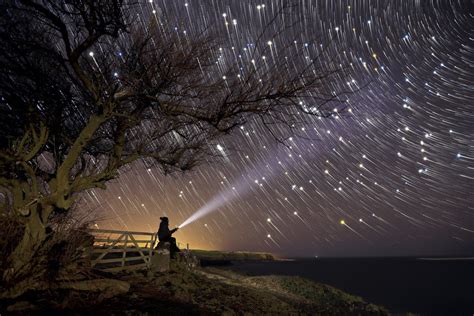 Time Lapse Photography Of Stars Moving In The Sky With Some Guy With A