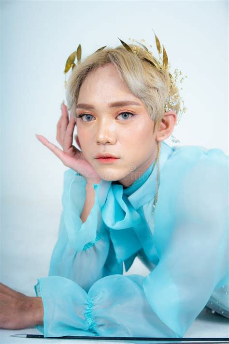 A Woman With Flawless Makeup Wearing A Golden Crown On Her Blonde Hair Stock Photo Image Of