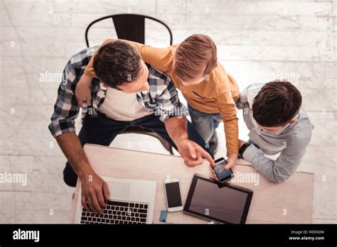 Blonde Haired Son Holding Smart Phone Calling His Mother Stock Photo Alamy