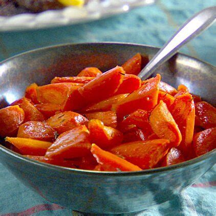 a bowl filled with sliced up carrots on top of a blue cloth covered table