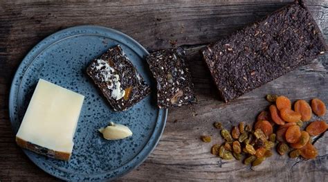 Three Different Types Of Food On A Blue Plate With Nuts And Crackers