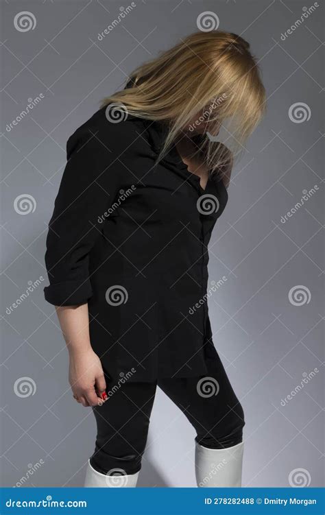 Sensual Mature Confident Caucasian Woman In Black Shirt Over Dark