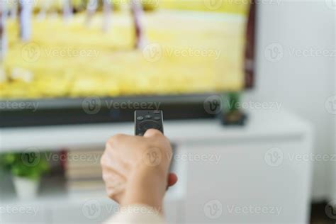 Elderly Woman Watching Smart Tv And Using Remote Controller Hand