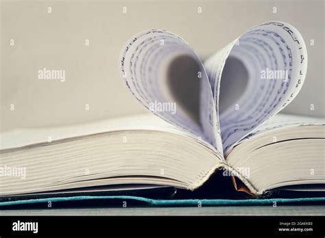 Book Pages Curved Into Heart Shape On Gray Background Stock Photo Alamy