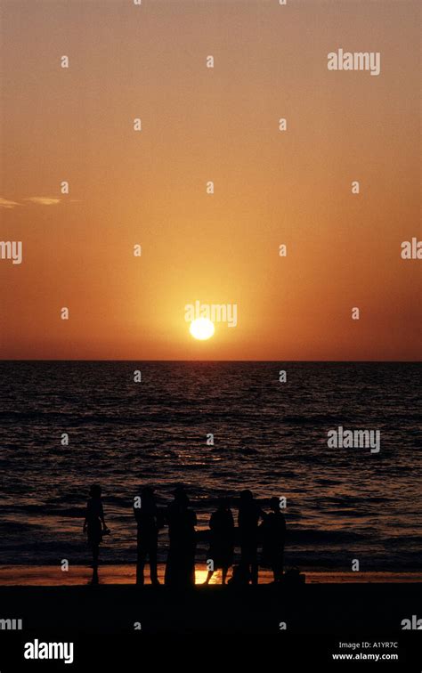 WATCHING SUNSET ON CALANGUTE BEACH Stock Photo - Alamy