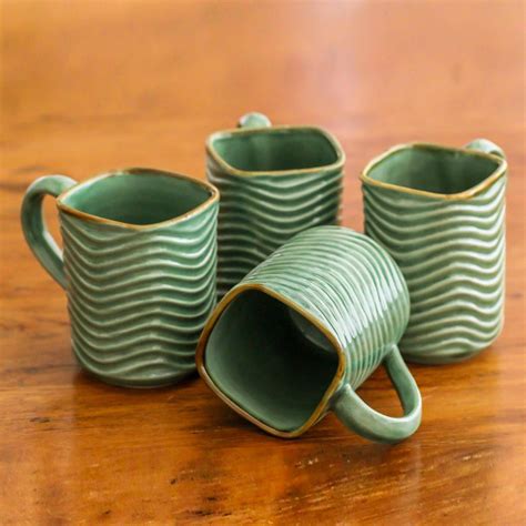 This set of four ceramic mugs is brimming with texture. The mugs ...