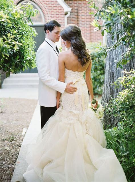 A Man And Woman In Formal Wear Standing Next To Each Other On A