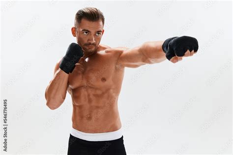 Man Athletic Bodybuilder Poses In Boxing Gloves With Nude Torso Abs In