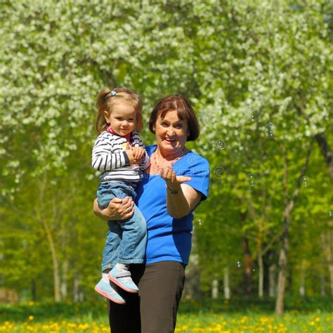 Grandmother Holds Her Granddaughter In Her Arms Stock Image Image Of