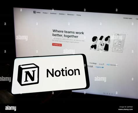 Person Holding Cellphone With Logo Of US Software Company Notion Labs