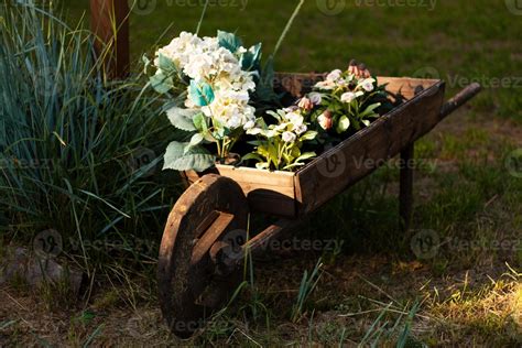 Photo a wooden cart with plants and flowers. 10758585 Stock Photo at Vecteezy