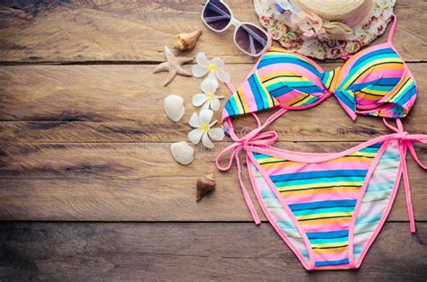 Beauty Colorful Bikini And Accessories On Wooden Floor Stock Photo