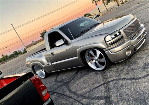 A Silver Truck Parked In A Parking Lot