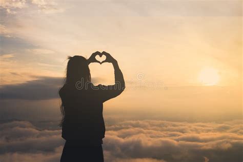 Silhouette of Female Holding Hands in Heart Shape. Stock Image - Image of hands, outdoor: 144083311