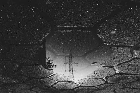 Premium Photo Reflection Of Electricity Pylon On Puddle