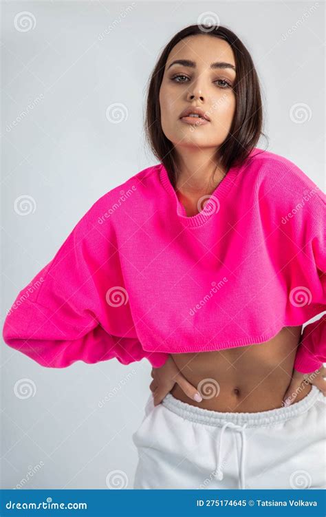 Vertical Dark Haired Confident Glorious Woman With Posh Makeup In Pink Shirt With Naked Tummy